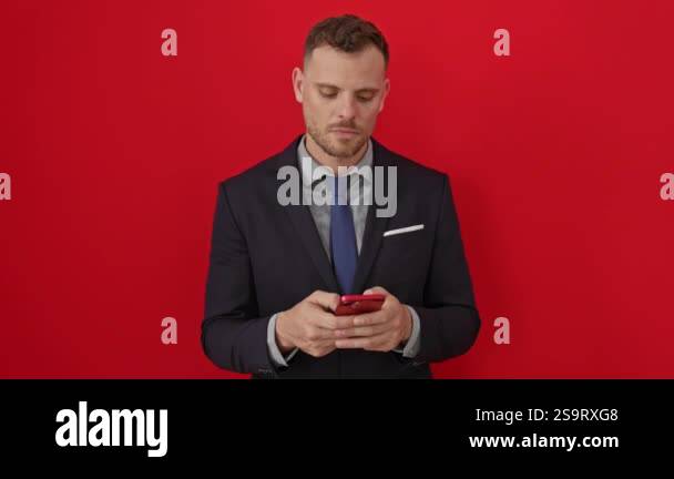 Furious young hispanic man in suit, shouting angrily over smartphone ...