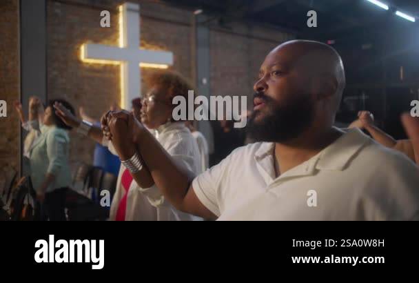 Congregation holding hands during worship, standing in unity and faith ...
