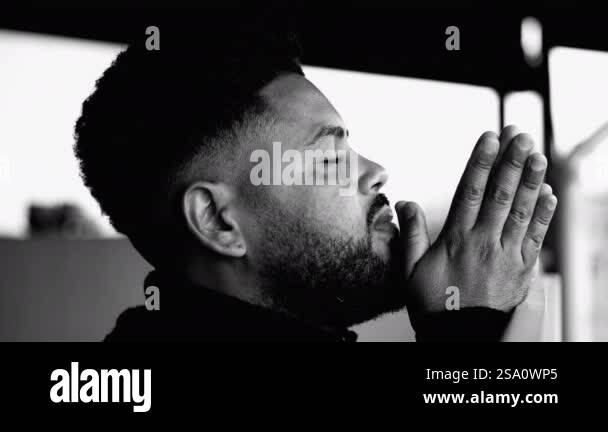 One Spiritual young black man in deep PRAYER contemplating GOD and ...