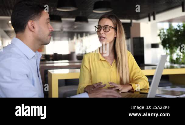 Female sales manager showing details of proposal, contract draft or ...