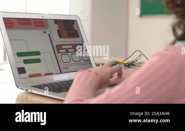 Back view of american girl coding engineering prompt while laptop ...