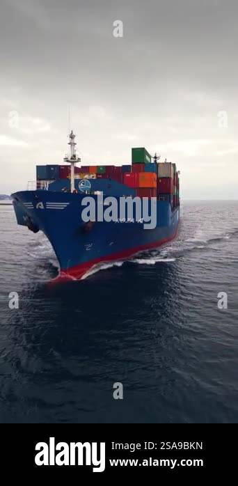 Front view of a blue container ship Roza A sailing through calm waters ...