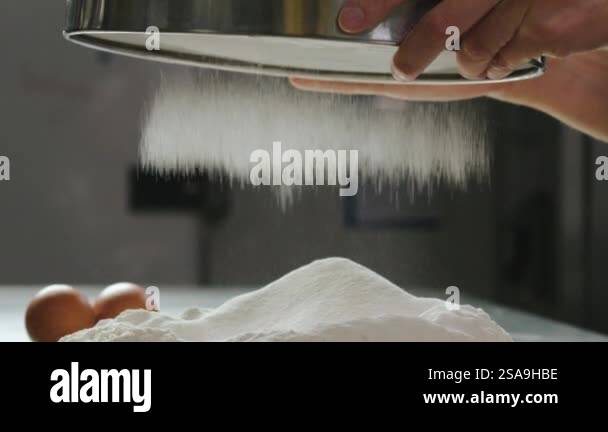 The cook sifts the flour through a sieve. Slow motion. High quality 4k ...