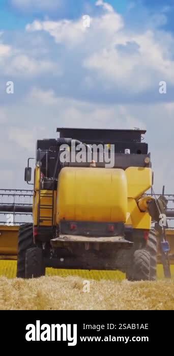Back view of agricultural machine in work. Contemporary combine ...