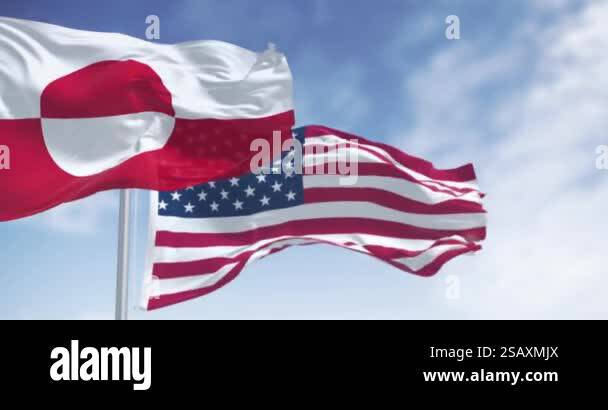 Flags of Greenland and the US waving in the wind on a clear day ...