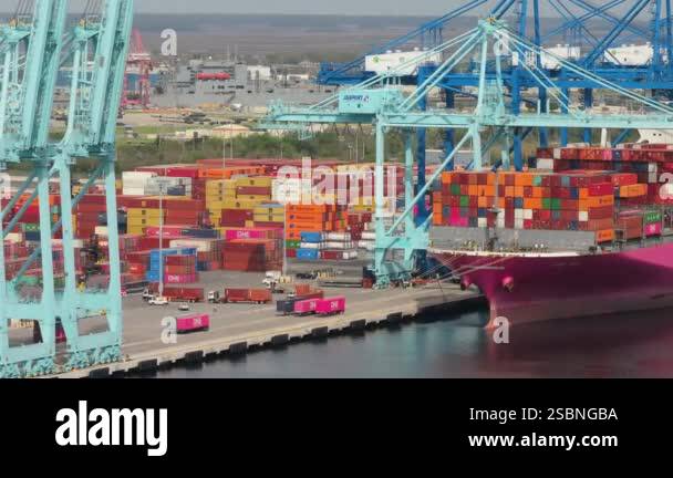 Crane unloading freight containers from cargo ship in sea port of ...