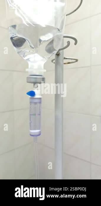 IV drip on the background of tiles in the hospital. The infusion system ...