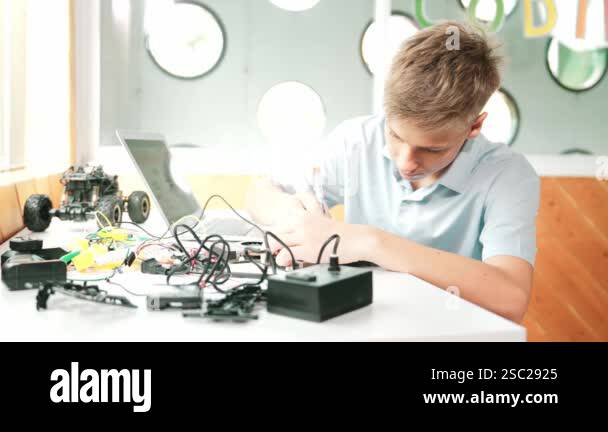 Caucasian boy fixing main board while study construction by using ...
