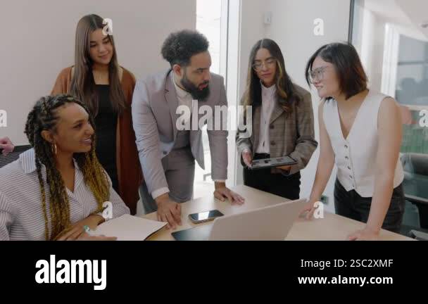 In a modern and stylish office environment, diverse group of dedicated ...