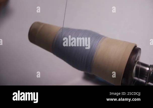 Continuous spinning motion of a thread on a spool, moving in a seamless ...
