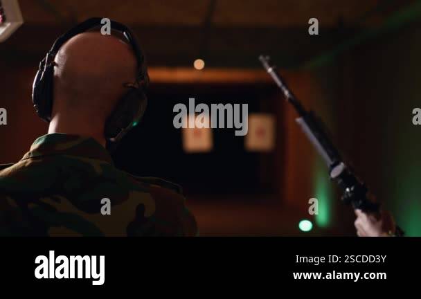 Team of army soldiers practicing with firearms in shooting range to ...