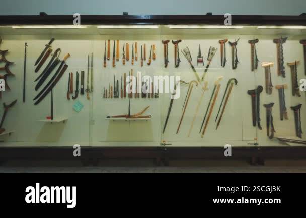 A display case filled with various traditional weapons and tools ...