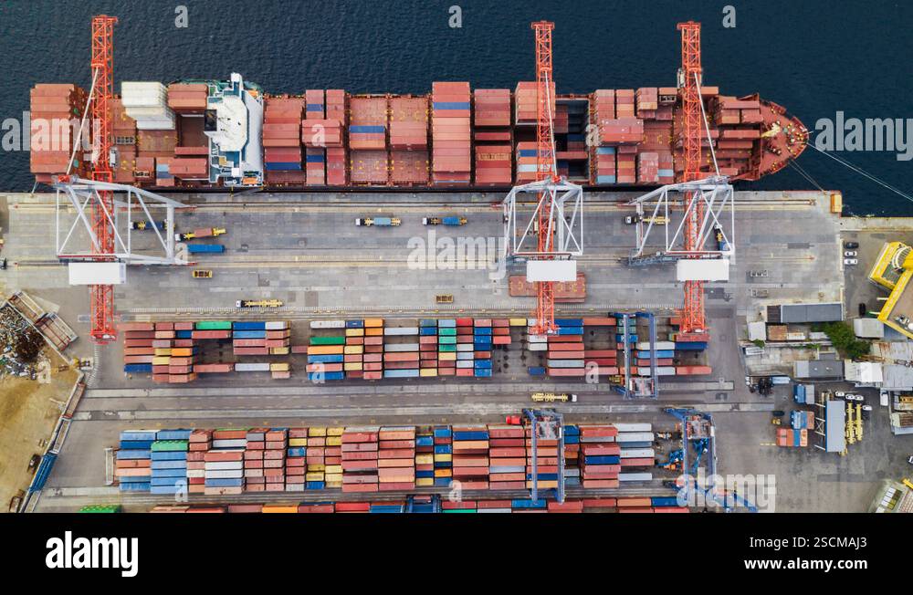Top down aerial view of cargo ship loaded with containers loading and ...