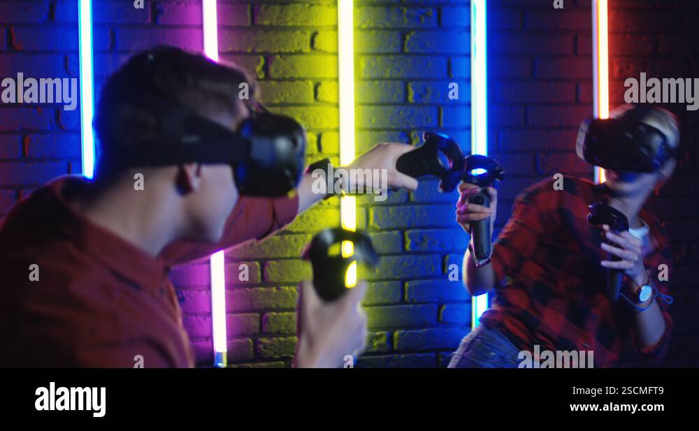 Close up of the intense virtual reality shooting game between Caucasian ...