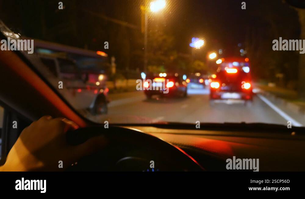 blur, first person view. hand on the steering wheel of the car. driving ...