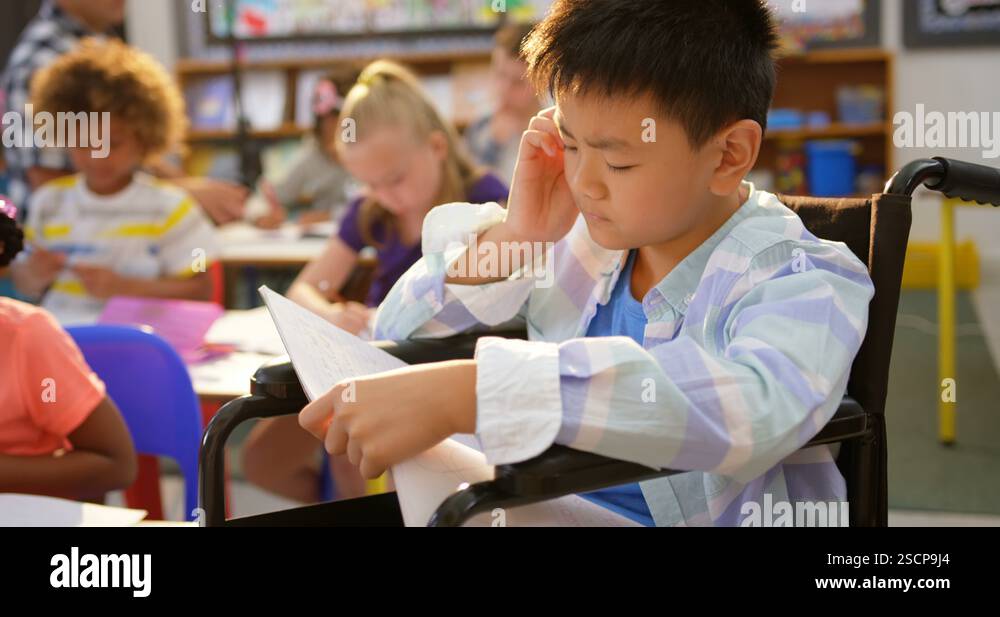Front view of Disabled Asian schoolboy studying in the classroom 4k ...