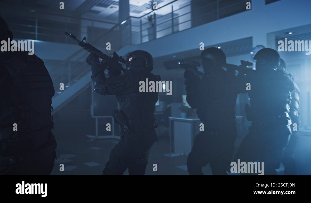 Masked Team of Armed SWAT Police Officers Slowly Move in a Hall of an ...