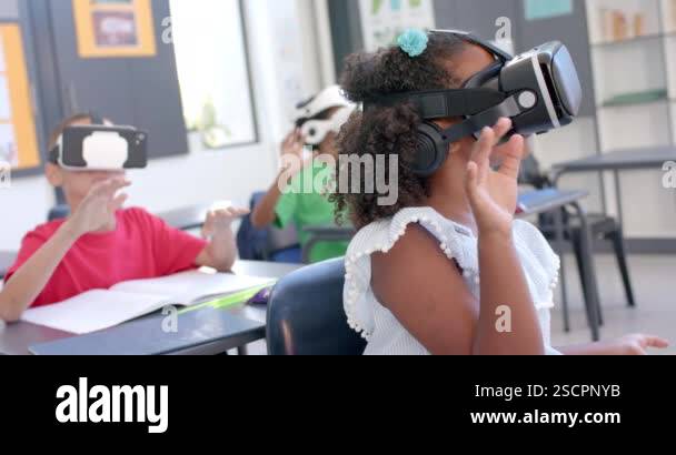 Biracial girl explores virtual reality in a classroom at school in a ...