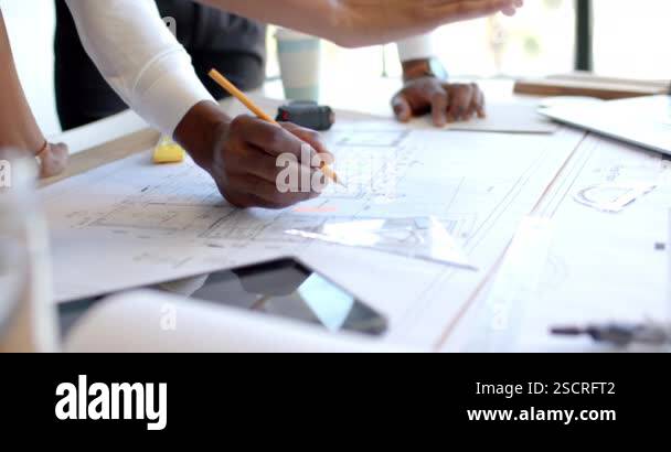 Blueprint Discussion Reviewing architectural blueprints, business professionals ...