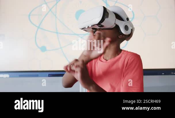 Using VR headset, boy engaging in virtual reality experience in school ...