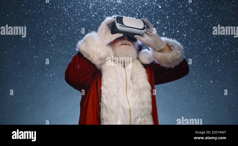 Santa claus is putting on vr helmet and surfing virtual reality ...