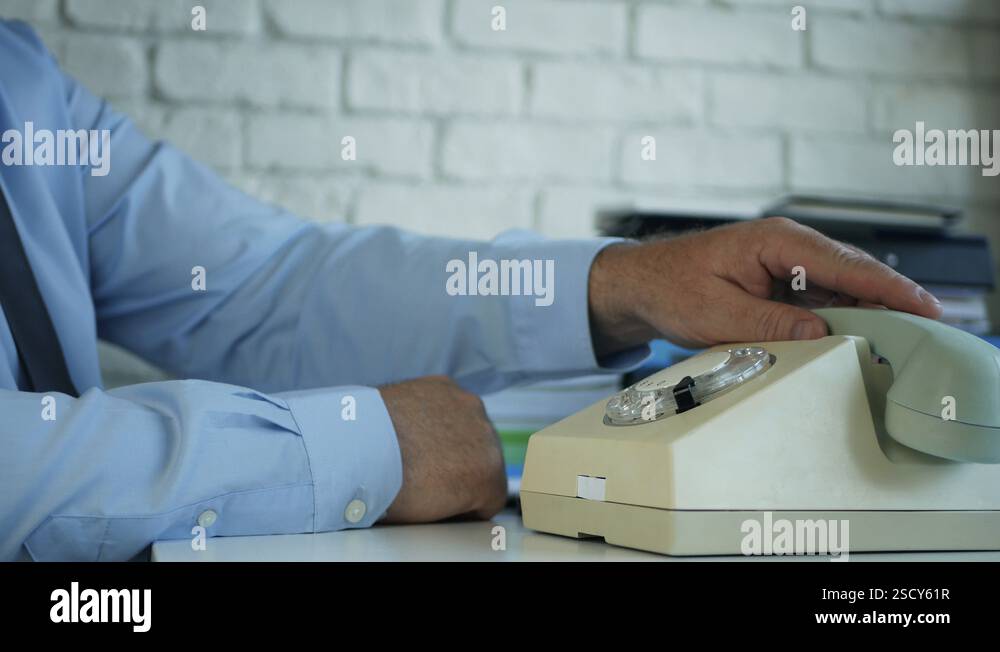 Businessman in Office Room Dial a Phone Number Using an Old Telephone ...