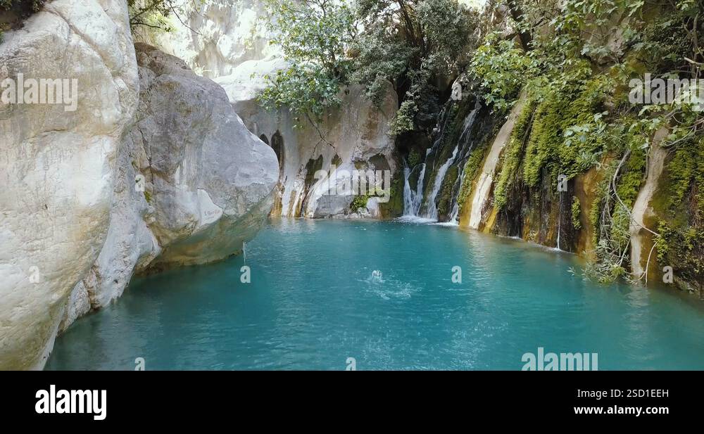 Splashing blue water in the Goynuk Canyon, rocks and a waterfall, 4k