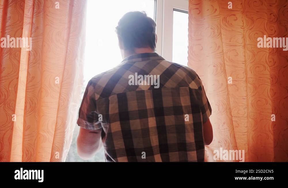 man shoots on a smartphone what is happening outside his window Stock ...