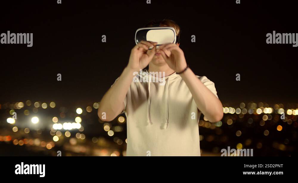 Young caucasian guy trying on vr glasses, diving into virtual reality ...