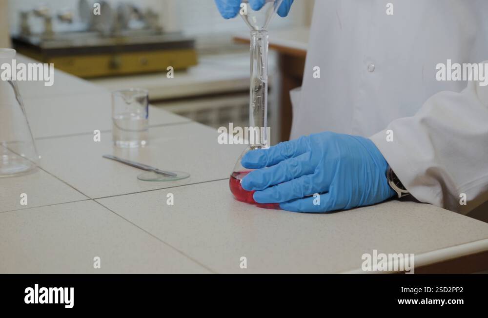 Male scientist with test tubes in a laboratory conducts an experiment ...