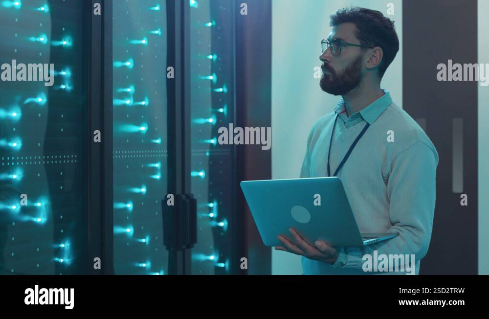 Smart IT specialist running rack server diagnostics on laptop computer ...