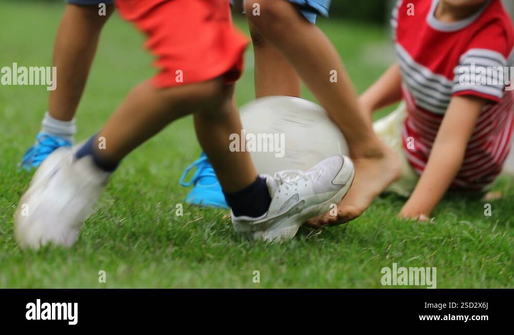 Child falling to the ground while playing soccer Kid drops to the Child falling to the ground while playing soccer Kid drops to the
