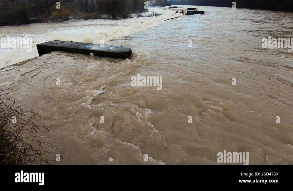 Slow motion wide flooded chaotic river flowing over cascades after ...
