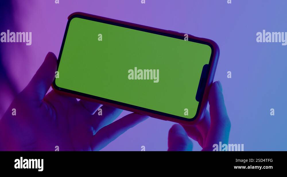 Female holding smart phone, horizontal orientation, colorful neon ...