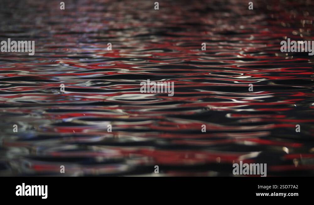 Rippling water surface with red light reflection Stock Video Footage ...