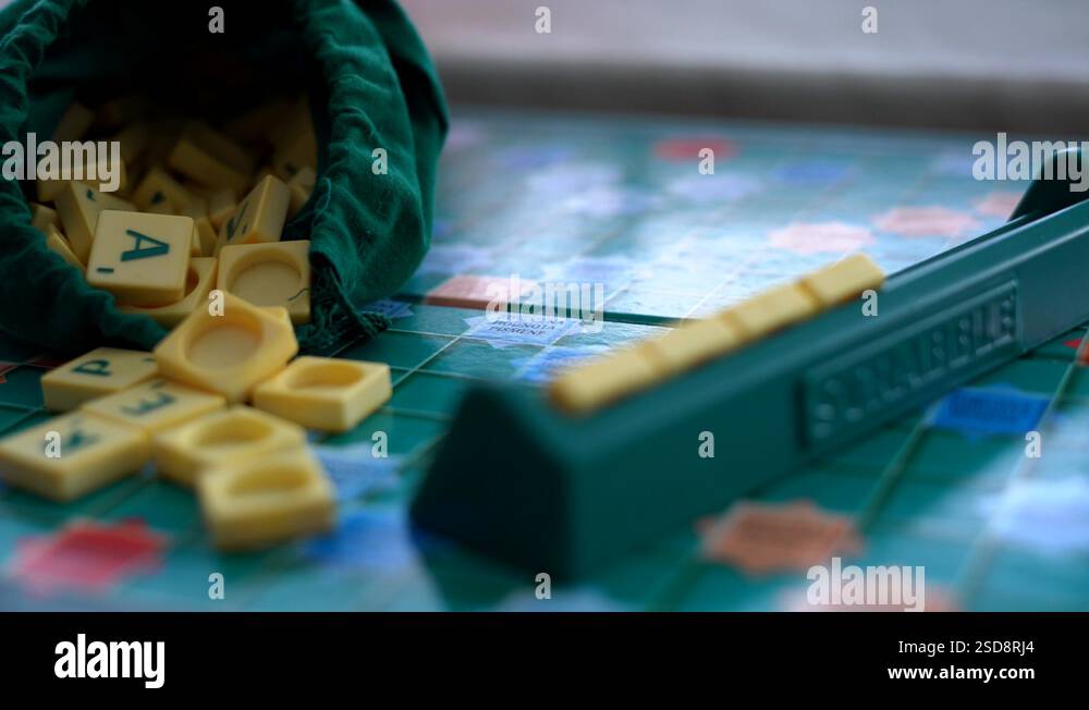 Random Scrabble game letter tiles with score value coming out Stock ...