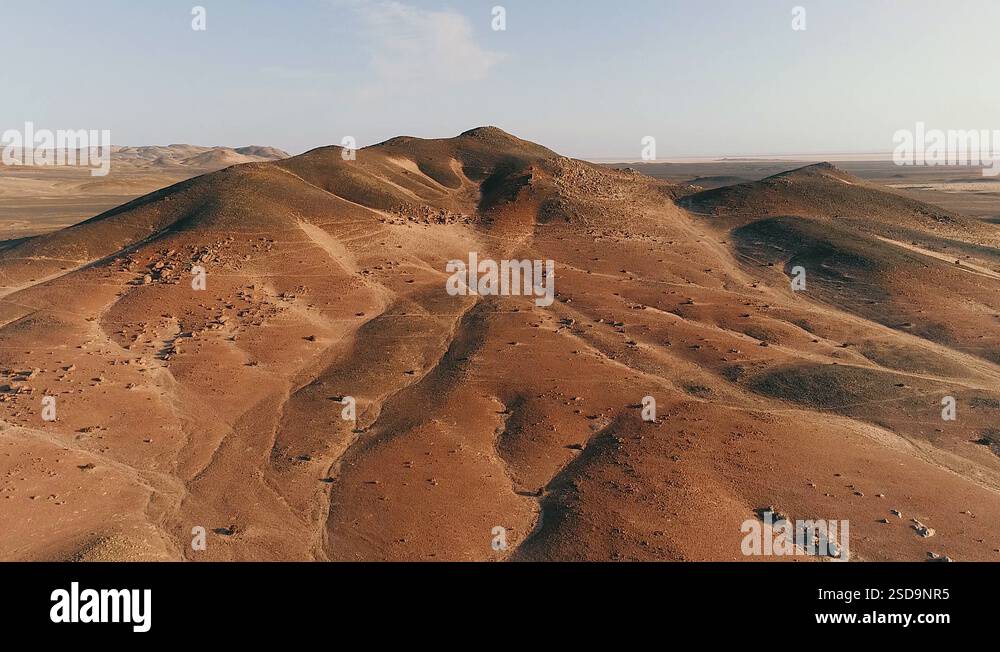 flight over the ridge opens up views of a desert flat valley in Namib ...