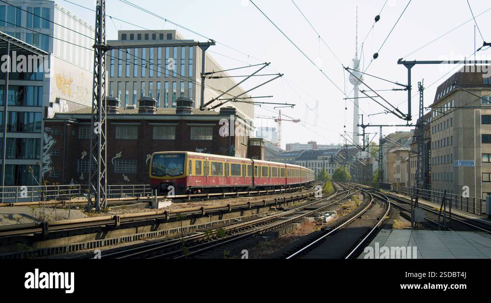 berlin-metro-passing-train-station-on-sunny-day-with-tv-tower-in