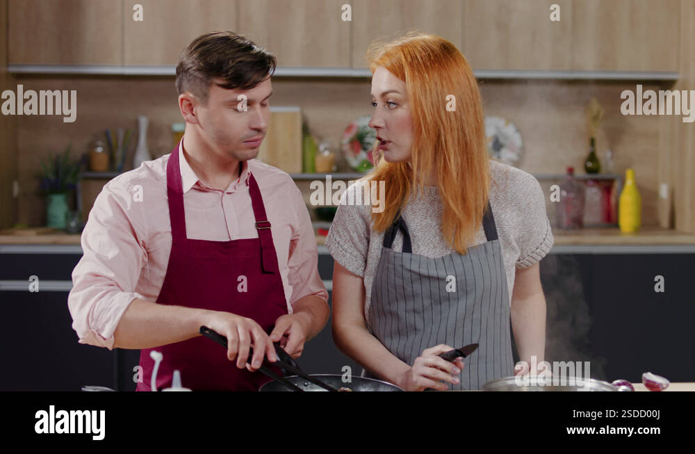 Cooking show hosts chefs, male and female, cooking meat. TV cooking ...