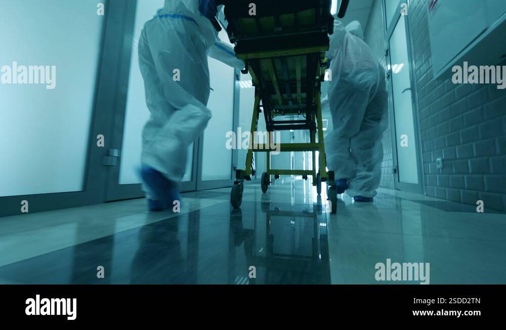 Paramedics are pushing a rolling table along the hall Stock Video ...