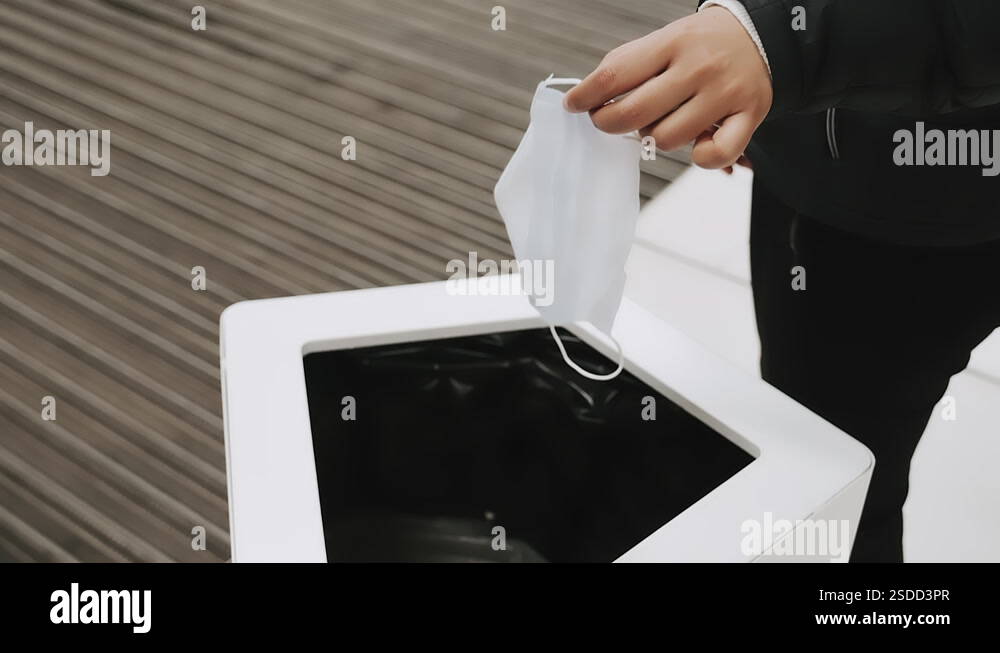 Throwing medical mask in garbage bin, trash. Problem of sorting ...