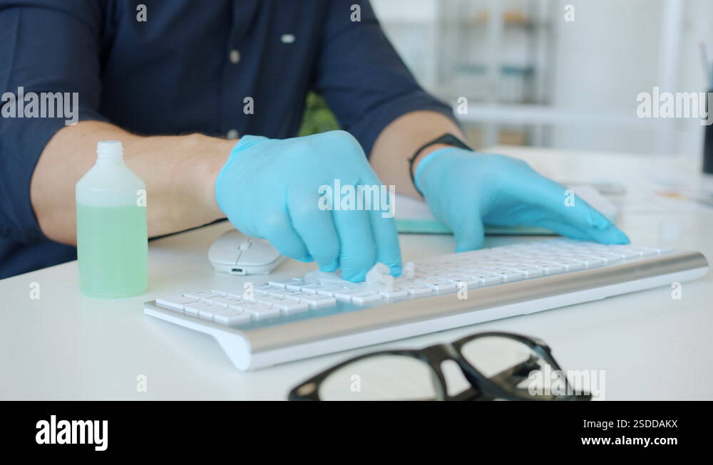 Close-up slow motion of office worker's hands in gloves wet wiping ...