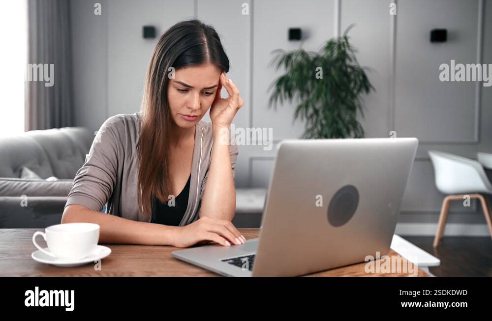 Upset young female feeling tired massaging temples sitting at desk. 4k ...