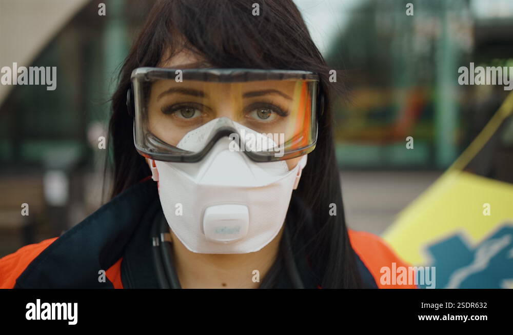 Sad female paramedic stares at you feeling alert standing near ...