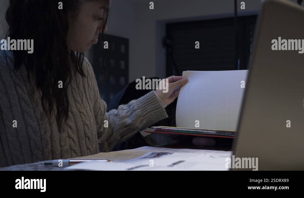 Female Teenage Student Taking Homework Out Of Folder At Home. Locked ...