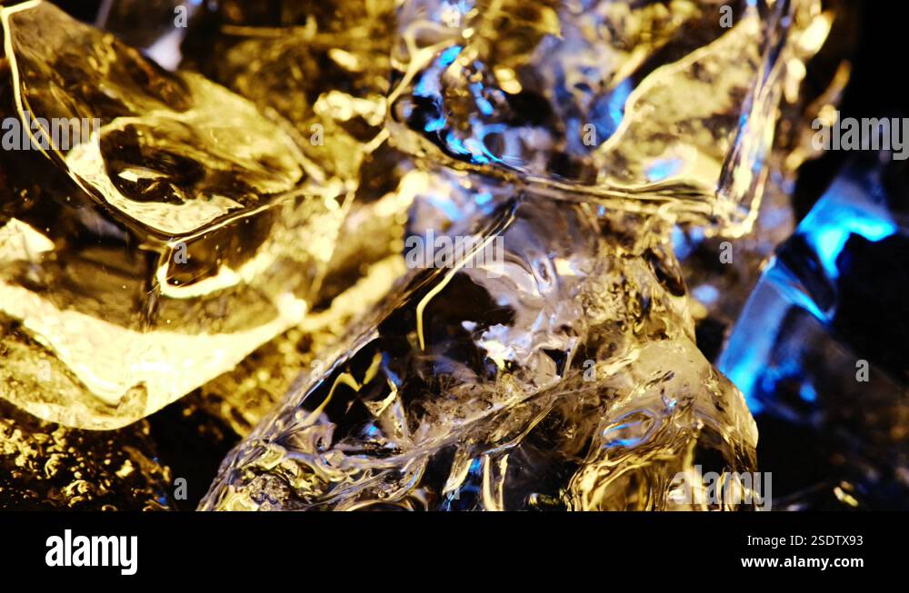 Ice cubes rotate on an axis. 4K color yellow and blue wallpaper Stock ...