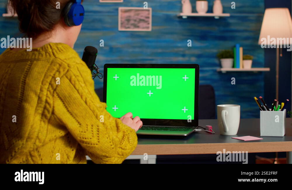 Blogger typing at laptop with green screen display Stock Video Footage ...
