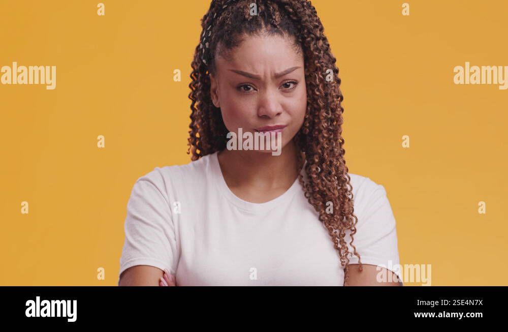 Young grumpy offended african american woman looking at camera with ...