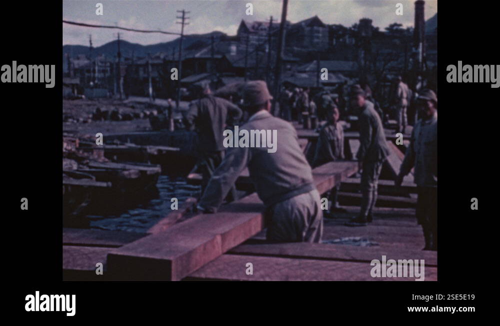 1940s Nagasaki: Neighborhood, water, power lines. Soldiers build bridge ...