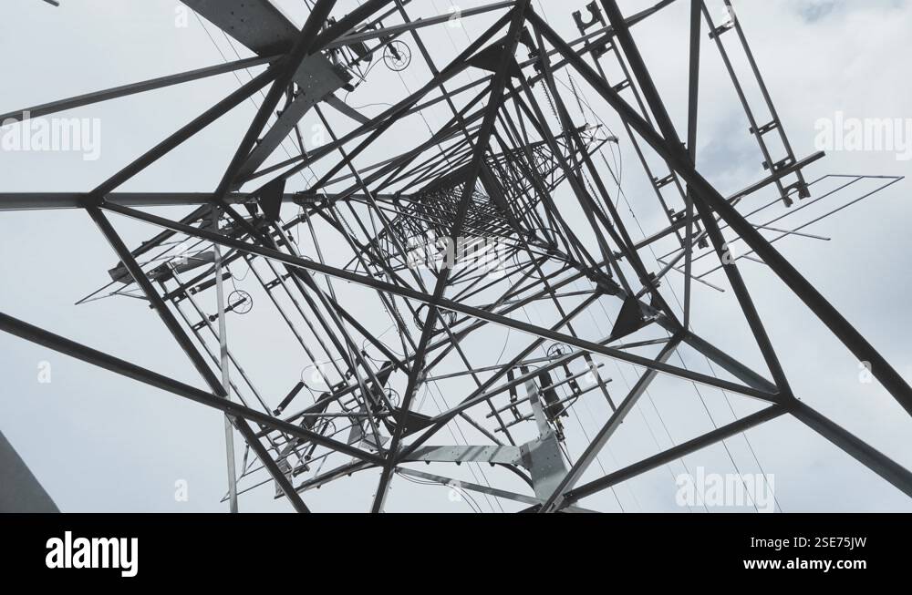 Huge Metal high-voltage tower with electric wires, the bottom view up ...